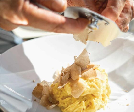 Truffle grated on italian pasta dish
